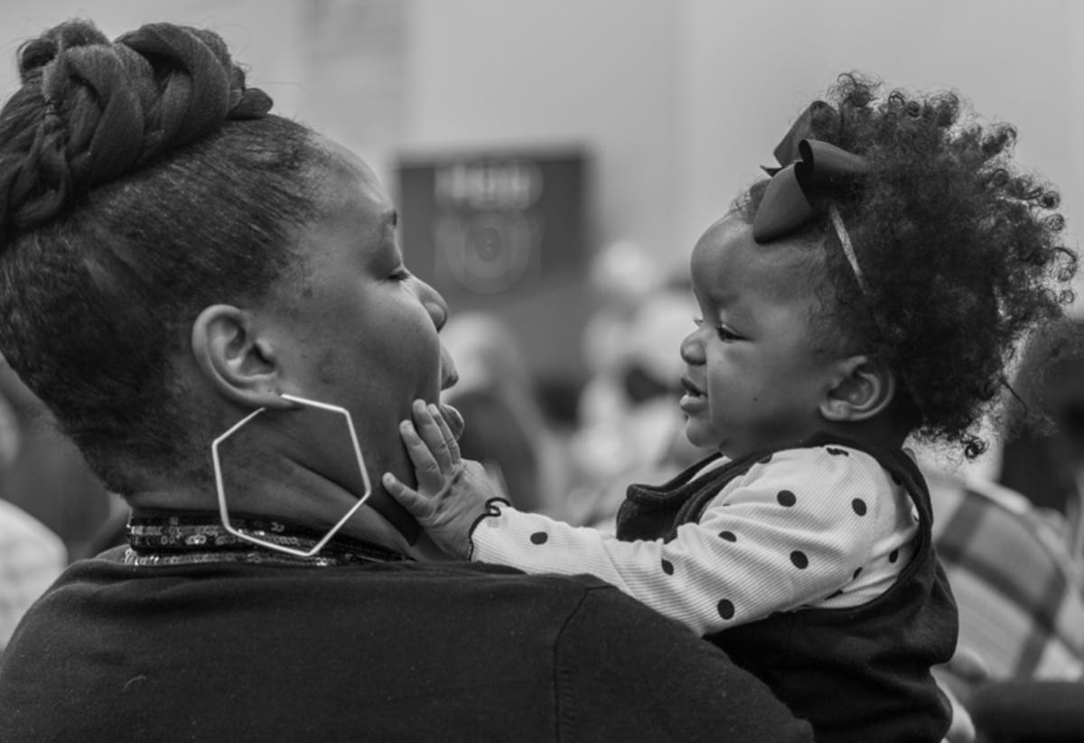 Mother holding daughter at The City Mission Mother holding daughter at The City Mission
