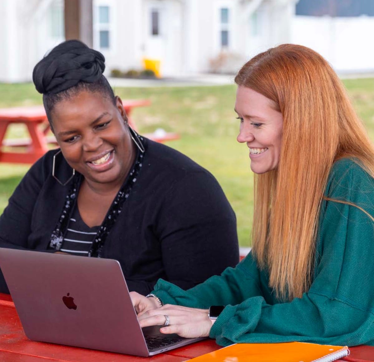 The City Mission staff helps mother with laptop The City Mission staff helps mother with laptop